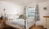 Bedroom 4 has a gorgeous bedstead and far reaching sea views.  - Thumbnail Image