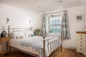 Bedroom 4 has a gorgeous bedstead and far reaching sea views.