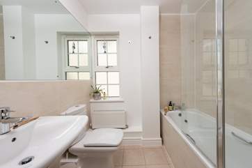 The family bathroom has a bath with shower over.