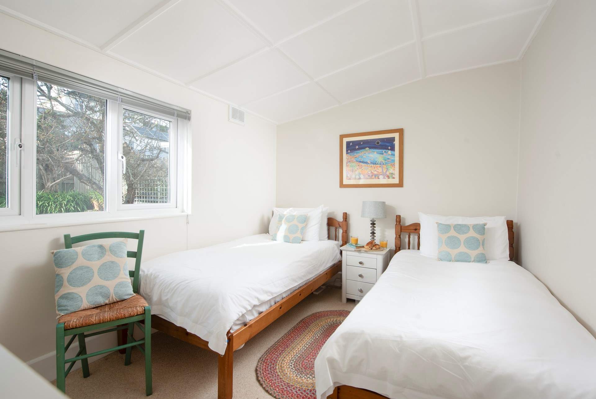 Bedroom 4 has twin beds and a handy wash-basin.