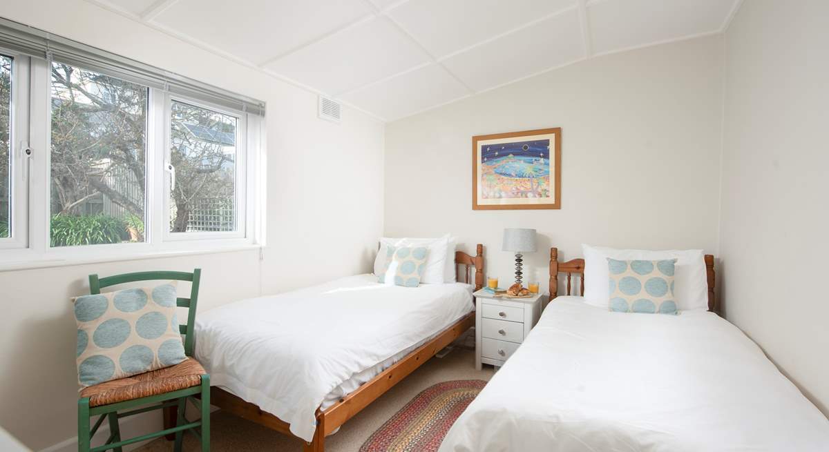 Bedroom 4 has twin beds and a handy wash-basin.