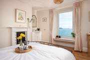 Bedroom 1 has a king-size double bed and wash-basin located in the corner.