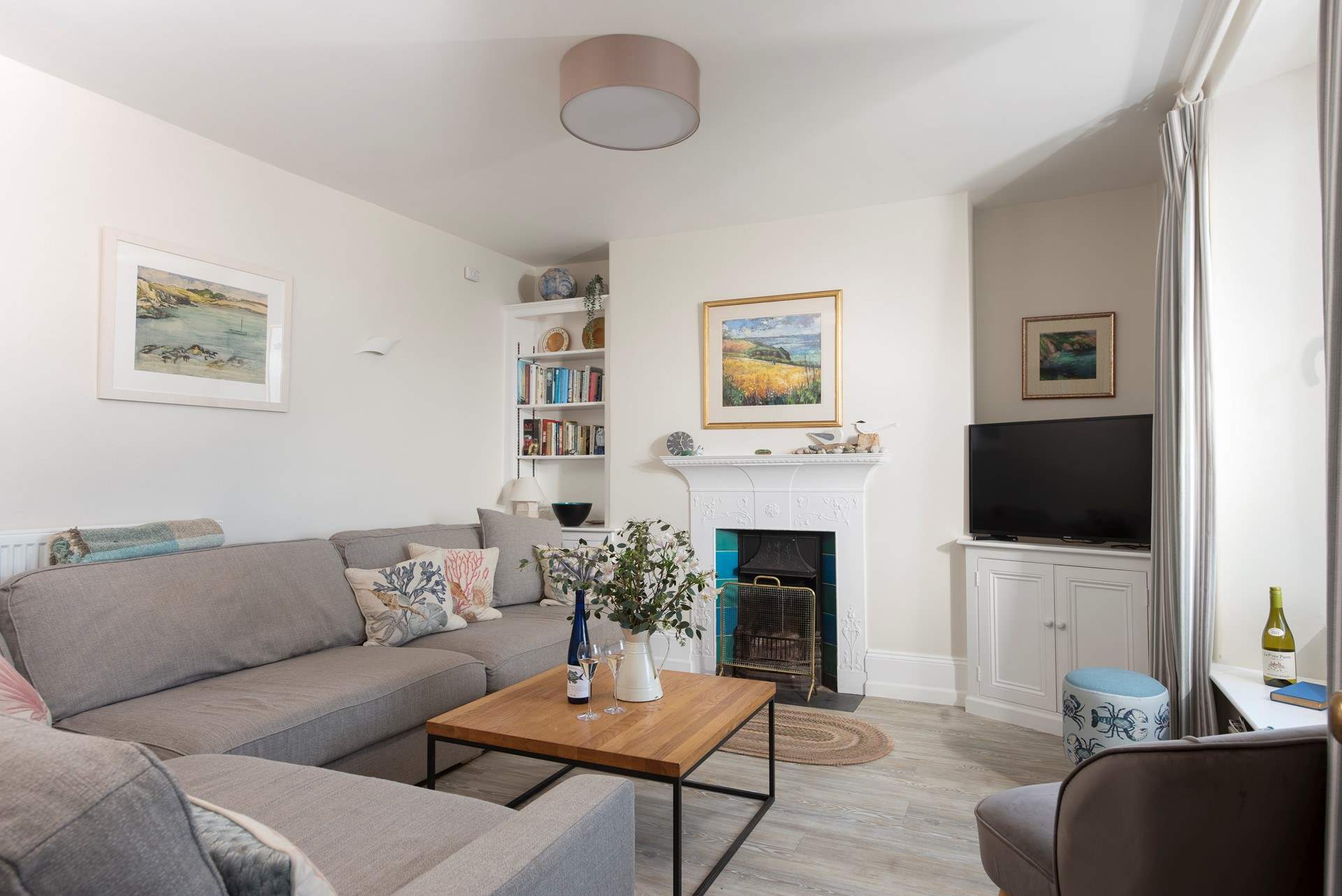 The sitting-room is warm and welcoming. Please note the open fire has been replaced with a cosy wood-burner.