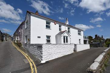 The exterior of the house (parking is just past the front of the house under the raised terrace).