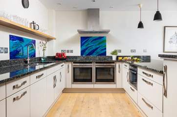 The super sleek kitchen has all the equipment you'll need to create a culinary delight.