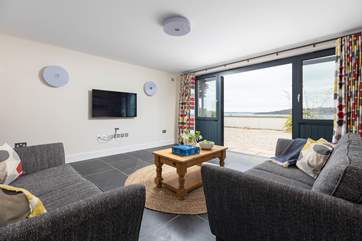 The family sitting-room on the ground floor has a Smart TV, ideal for relaxing in front of a movie after a busy day.