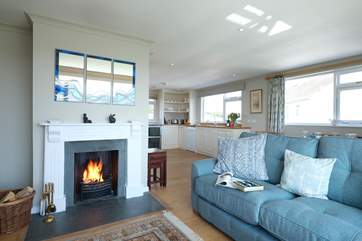 Sofas flank the open fire in the sitting-room.