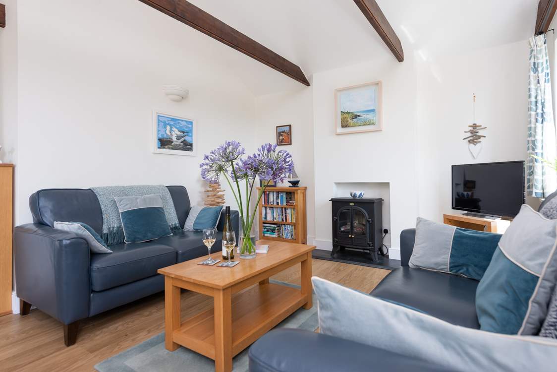 The pretty sitting-room is cosy and characterful.