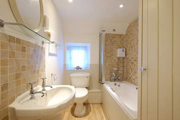The bathroom has a three-quarter size bath.