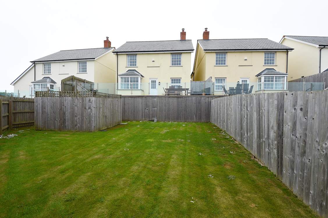 Steps lead down from the deck to the lawn below.