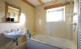 The bathroom has a bath with shower over. - Thumbnail Image