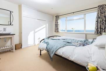 The double bedroom has room wide windows, the perfect place to take in the view.