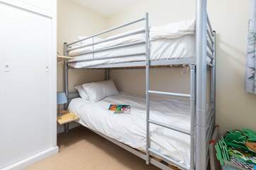 The bunk room is next door to the twin room.