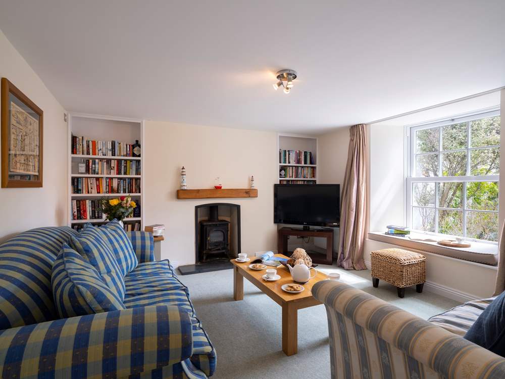The sitting-room at the front of the house overlooks the garden.
