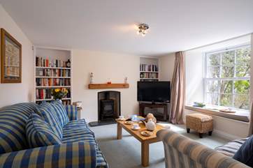 The sitting-room at the front of the house overlooks the garden.