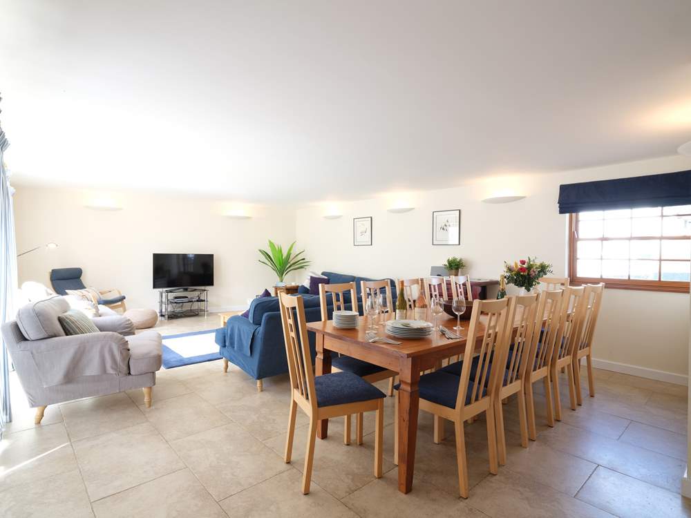 The open plan living/dining-room fills with natural light.