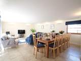 The open plan living/dining-room fills with natural light.