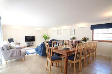 The open plan living/dining-room fills with natural light.