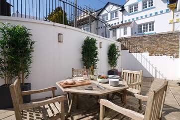 The courtyard off the open plan living/dining-room is a delightful place for al fresco dining.