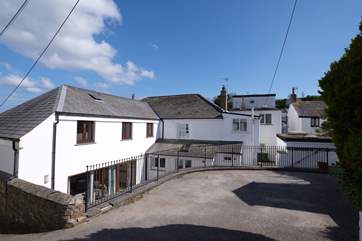 The parking area is at the rear of the property.