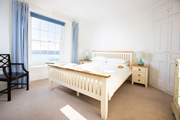 Bedroom one with a king-size bed and outreaching views towards Falmouth and St Anthony Head.