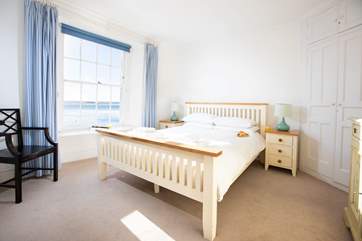 Bedroom one with a king-size bed and outreaching views towards Falmouth and St Anthony Head.