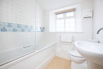 The family bathroom with an overhead shower in the bath.