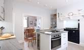 The kitchen area showing the ornamental Rayburn, looking towards the dining-room. - Thumbnail Image