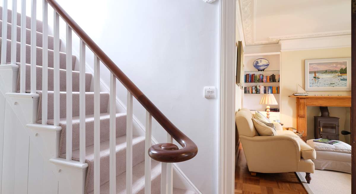 The elegant staircase leads up from the front hall.