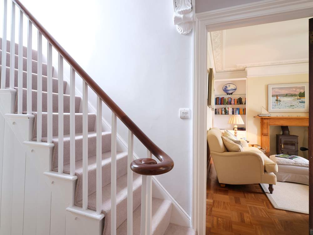 The elegant staircase leads up from the front hall.