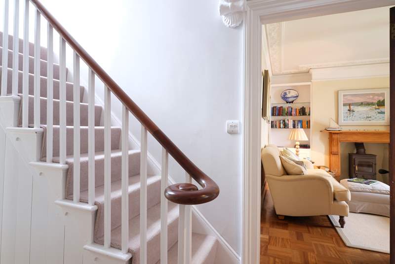 The elegant staircase leads up from the front hall.