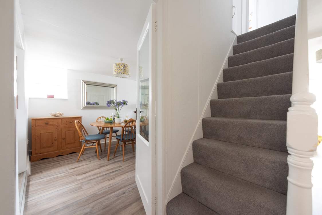 Traditional steep cottage stairs lead up to the first floor.
