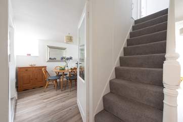 Traditional steep cottage stairs lead up to the first floor.