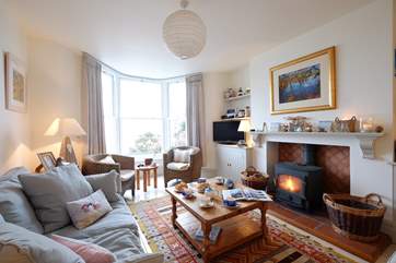The sitting/dining-room has a cosy wood-burner.