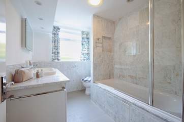 The family bathroom with an overhead shower in the bath.