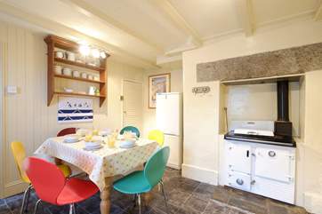The pretty dining-area with its ornamental Rayburn.