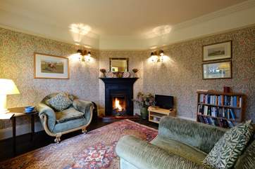 The sitting-room has an open fire.