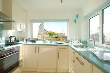 The open plan living space includes this pretty kitchen area.