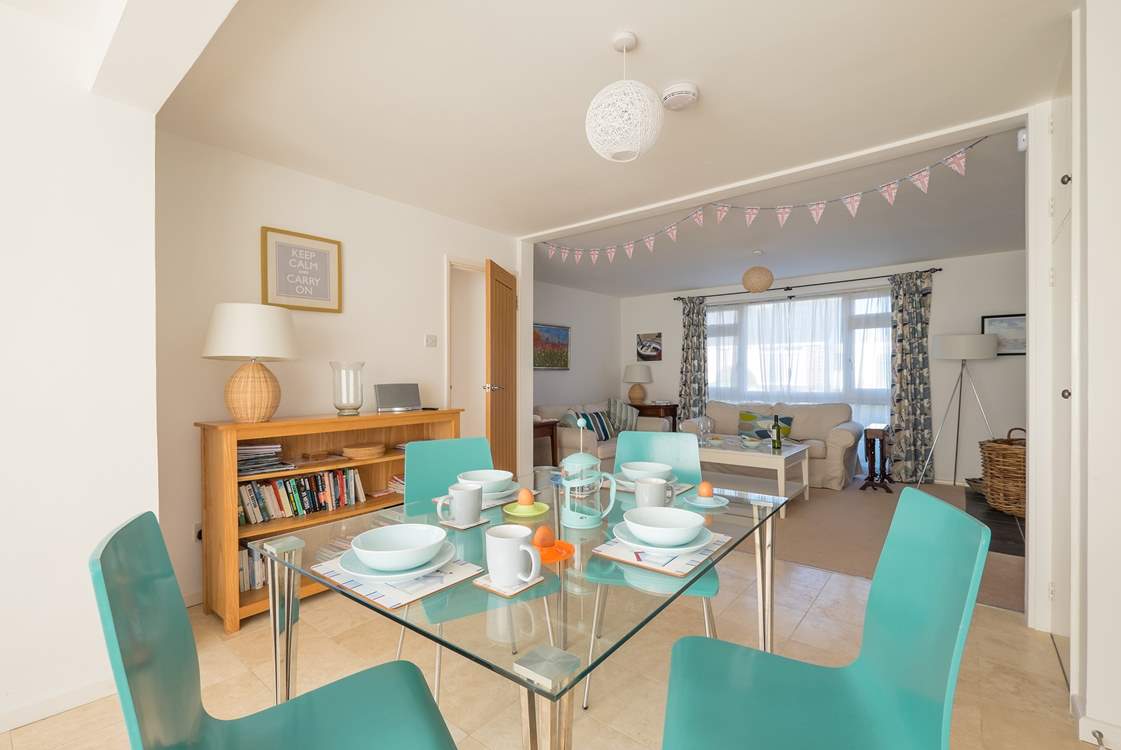 The dining table sits in between the sitting-room and the kitchen.