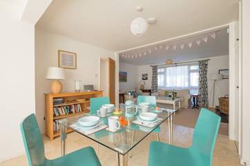 The dining table sits in between the sitting-room and the kitchen.