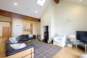 Sofas flank the wood-burner in the sitting/dining-room.