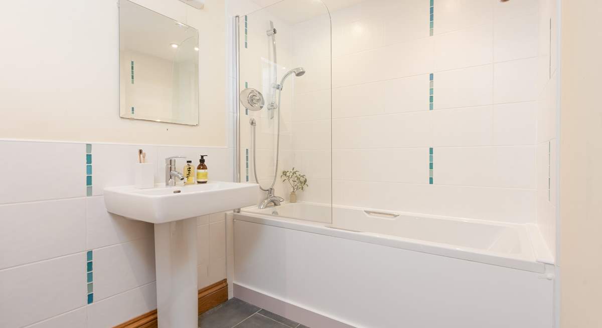 The family bathroom on the ground floor has a bath with shower over. 