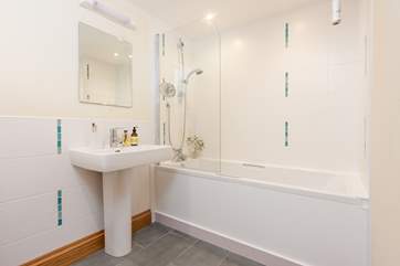 The family bathroom on the ground floor has a bath with shower over.