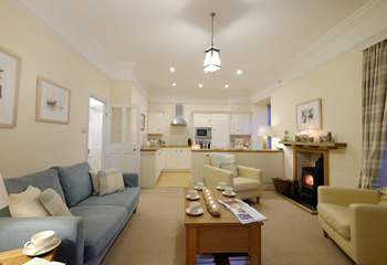 The kitchen and cosy sitting-area are open plan and warmed by a wood-burner.