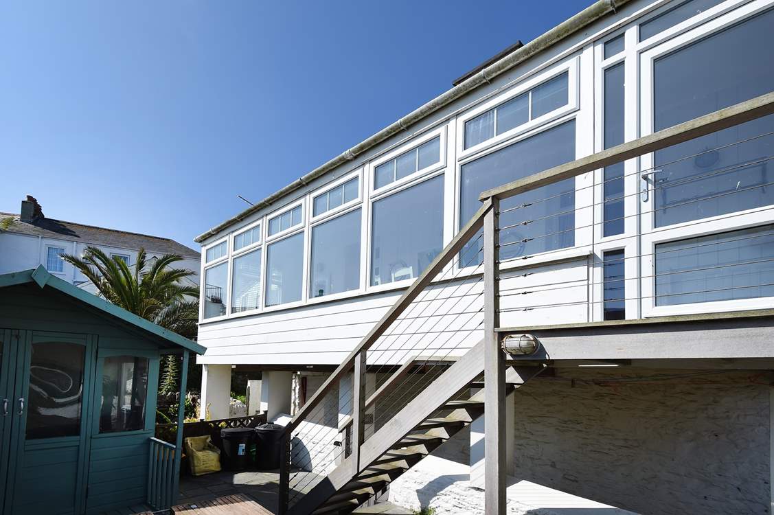 Climb the steps to this seafront apartment.