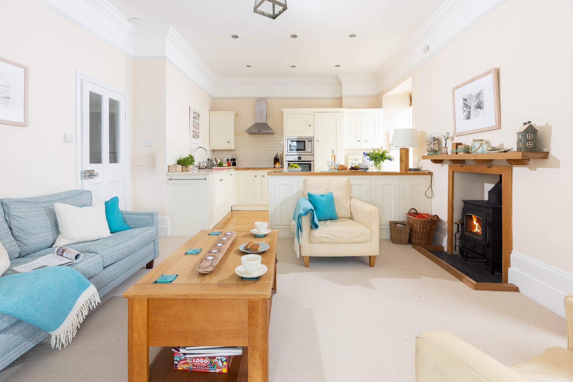 The kitchen and cosy sitting-area are open plan and warmed by a wood-burner.