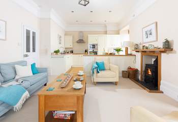 The kitchen and cosy sitting-area are open plan and warmed by a wood-burner.