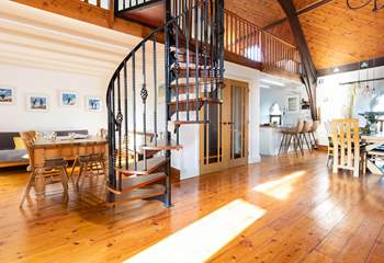 The characterful spiral staircase leads to the mezzanine level with pool table and table-tennis.