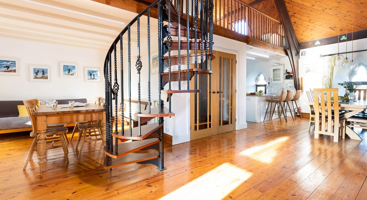 The characterful spiral staircase leads to the mezzanine level with pool table and table-tennis.