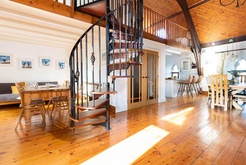 The characterful spiral staircase leads to the mezzanine level with pool table and table-tennis.